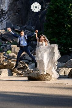 the bride and groom are jumping up in the air to catch the frisbee