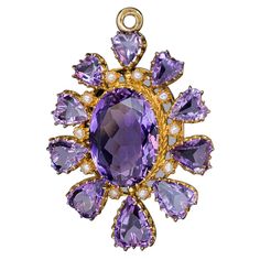 Circa 1870s-1880s This vibrant antique 14K gold pendant features sparkling lavender purple amethysts. It is centered with an oval amethyst, accented by small half pearls, and surrounded by ten heart-shaped amethysts which graduate vertically in size. The back of the pendant is fitted with a glazed miniature picture compartment. Marked with Austro-Hungarian fox head assay mark, "H” for the city of Bergen, and maker’s mark. The pendant measures (without bail) 42 x 33 mm (1 5/8 x 1 1/4 in.) Sold wi Victorian Pendant Necklace, Art Deco Pendant Necklace, Large Locket, Victorian Pendants, Antique Locket, Jewelry Purple, Austro Hungarian, Fox Head, Art Deco Pendant