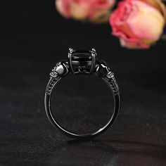 Sparkling and luxurious, this skull ring will capture your heart at first sight. Crafted in sterling silver, with two skulls both sides and a black round cut stone on the top. Perfect fit for engagement or wedding occasion. Simple design make it very comfortable and convenient for wearing everyday. She'll instantly fall in love with this design.Carat Weight: 3.9 ctStone Size: 1.5,1.2,1.0,0.8,8*8 mmNumber of Stones: 37 Stone Shape: Round, CushionStone Color: Fancy BlackWeight: 3.37 gWidth: 2.26 m Gothic Black Skull Ring, Black Sterling Silver Skull Jewelry, Black Skull Sterling Silver Jewelry, Gothic Black Skull Ring For Halloween, Black Skull Rings As Gift, Black Skull Jewelry For Formal Occasions, Black Skull Rings For Gift, Black Skull Print Ring, Formal Black Skull Jewelry