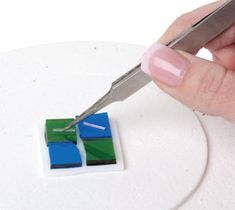 a person is cutting through a piece of paper with a pair of scissors