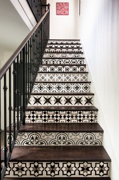 the stairs are decorated with black and white tiles