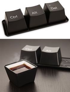 a computer keyboard with three different types of buttons on it and one has coffee in the middle