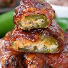 some food is stacked on top of each other in front of a plate with green beans