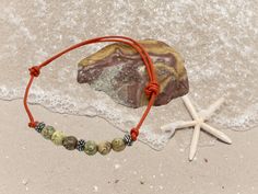 This handmade leather anklet is made with leather cord, bronze beads, and agates. With summer just about upon us,  this is the perfect addition to your beach jewelry. The round leather cord is a rich orange color that will definitely compliment your tan. The anklet is adjustable. By sliding the knots you can make the anklet large enough to fit over your foot. Once you have it on you can then slide the knots to make it smaller to fit comfortably on your ankle. To keep your leather anklet looking as nice as when you bought I do not recommend wearing it in the shower or the water. Beach Jewellery, Leather Anklets, Anklet For Women, Ankle Jewelry, Jewelry Beaded, Round Leather, Bead Leather, Anklet Jewelry, Beach Jewelry