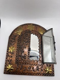 an ornate mirror is hanging on the wall