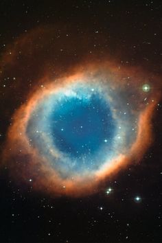 a blue ring in the center of a star filled sky with stars all around it