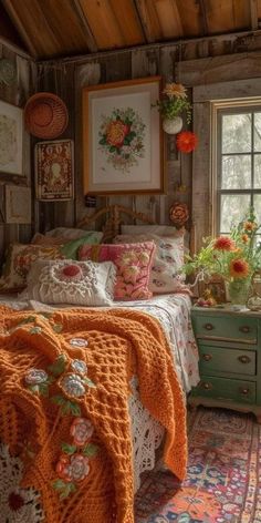 a bedroom with a bed, dresser and window covered in pictures on the wall next to it