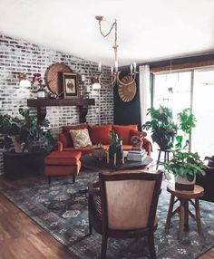 a living room filled with furniture and plants