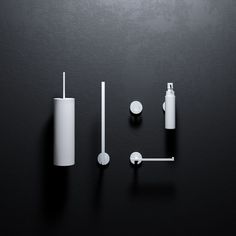 three different types of bathroom accessories on a black surface, including soap dispenser and toothbrush