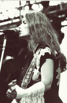 an image of a woman singing into a microphone