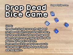 a wooden table topped with blue dices on top of it's sides and the words drop dead dice game