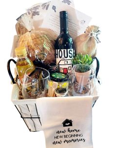 a basket filled with wine, food and other items for a housewarming gift