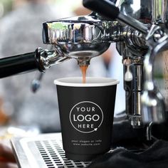 an espresso machine pouring coffee into a cup