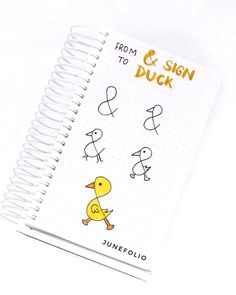 a spiral notebook with an image of a duck and the words from & sign to duck on it