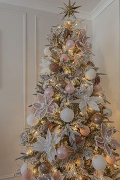 Blush pink Christmas tree with pink baubles white baubles gold tree topper star and pink, white and gold poinsettias on a snowy flocked Christmas tree Blush Christmas Tree Decorations, Pink Blush Christmas Tree, Pink Gold And White Christmas Tree, Xmas Tree With Pink Ornaments, Pink And Silver Xmas Tree, White Gold And Pink Christmas Tree, Dusty Rose And Gold Christmas Tree, Christmas Tree Rose Gold And White, Pink Decoration Christmas Tree