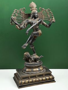 a bronze statue of a person with wings