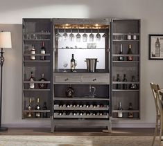 the bar is built into the wall in the living room, and has wine glasses on it