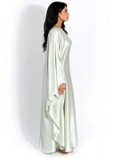 Embrace elegance in our new satin cloak, featuring long sleeves and a loose fit for comfort and style. With an O-neck design, this long dress exudes sophistication, perfect for ladies who seek a fashionable yet relaxed ensemble for any occasion. Details: Fit Type: Slim Neckline: O-Neck Material: Silk Material: SPANDEX Closure Type: Pullover Waistline: Natural Elegant Flowy Spring Abaya, Evening Long Sleeve Satin Maxi Dress, Elegant Evening Abaya With Cape Sleeves, Elegant Abaya With Cape Sleeves For Evening, Long Sleeve Dress With Draped Sleeves, Spring Long-sleeve Satin Dress With Satin Finish, Flowy Silk Long Sleeve Maxi Dress, Long Sleeve Long Dress For Wedding, Elegant Abaya With Cape Sleeves