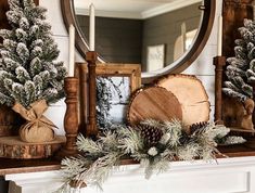 a mantel decorated for christmas with pine cones, evergreen and other holiday decor items