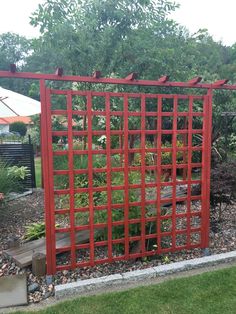 a red gate in the middle of a garden