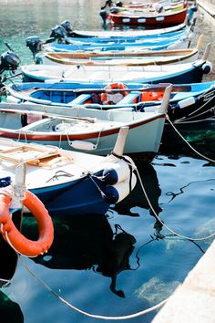 there are many small boats tied to the dock