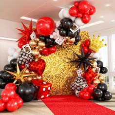 a room filled with balloons and other items in the shape of a star, heart, crown