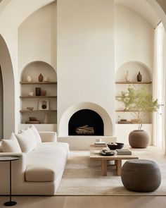 a living room filled with furniture and a fire place in the middle of a room