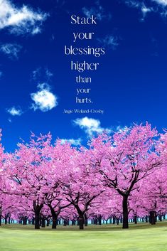 pink trees with blue sky and clouds in the background that says, stack your blessings higher than hurts