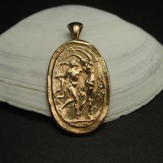 Handmade Apollo god chasing Daphne, the river nymph cameo pendant.This god Apollo and Daphne necklace is an intaglio reproduction of the famous Bernini statue of Apollo chasing Daphne as she is changing into the laurel tree and is made from a reproduction of an antique pendant.This cameo represents the God Apollo chasing after his love, the maiden river nymph Daphne. Daphne refused his advance and turned into a bay laurel tree.Perfect as a bridesmaid gift.- Handmade cameo pendant- Solid yellow b Bernini Statue, Greek Mythology Costumes, River Nymph, Mythology Costumes, Apollo And Daphne, Bay Laurel Tree, Apollo God, God Sculpture, God Apollo