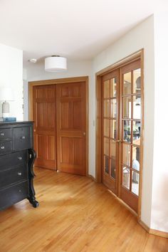 an empty room with wooden floors and doors