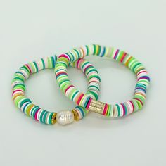 two bracelets with colorful beads on white background