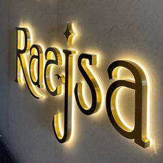 neon sign on the side of a building that says radisa in gold letters