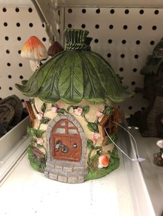 there is a small house made out of clay and has a mushroom on the roof