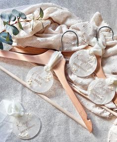 three personalized wooden spoons and two wedding hair pins