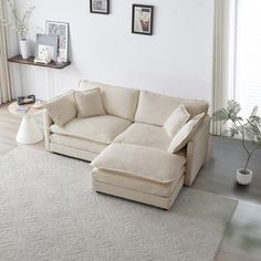 a living room with a sectional couch and white rug