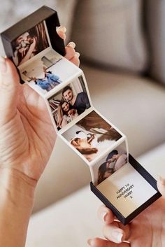 a woman holding up an open photo album with pictures on it's front and back sides