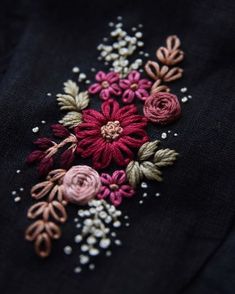 an embroidered flower on a black shirt