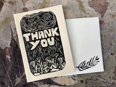 a thank you card with the words thank you written on it next to an envelope