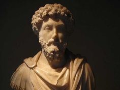 a statue of a man with curly hair and beard