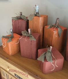 wooden blocks with burlocks tied to them sitting on a shelf in front of a wall