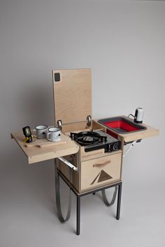 a small stove sitting on top of a wooden table