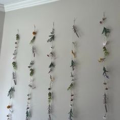 the wall is decorated with flowers and plants hanging from it's sides, along with other decorations