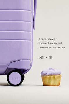 a purple piece of luggage sitting next to a cupcake