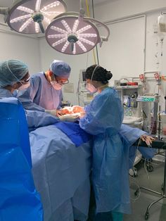 three doctors performing surgery in an operating room