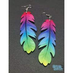 two pairs of colorful feathers are hanging from earrings