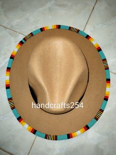 This is a beaded fedora hat. It's an adult size hat in the Lumbee tribe colors. Beaded Brim Hat, Handmade Multicolor Southwestern Hats, Handmade Southwestern Multicolor Hats, Handmade Fedora For Beach Costume, Handmade Turquoise Brimmed Hat, Handmade Fedora For Festival, Bohemian Beaded Adjustable Costume Hats And Headpieces, Bohemian Beaded Adjustable Costume Hats, Handmade Adjustable Green Hat Bands