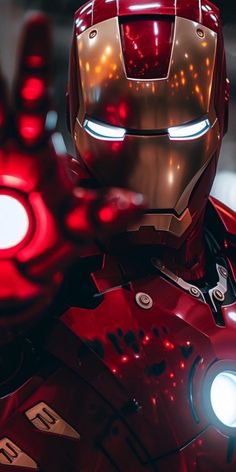 the iron man from avengers is shown with glowing eyes and hands in front of him