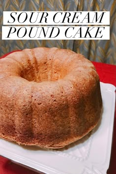 a bundt cake sitting on top of a white plate next to a red table cloth