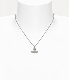 In homage to Vivienne's vision of launching tradition into the future, the Grace Bas Relief Pendant necklace showcases a two-dimensional orb motif at its center. The design receives a surface of white crystals decorating the silhouette, complete with polished, silver-tone plating to finish. Luxury Silver Necklace With Detachable Pendant, Designer Polished Finish Necklace, Luxury Silver Necklace With Shiny Finish, Elegant Silver Orb Jewelry, Elegant White Orb-shaped Jewelry, Designer Silver Diamond Necklaces, Elegant Orb-shaped Sterling Silver Necklace, Designer Silver Diamond Necklace, White Crystals