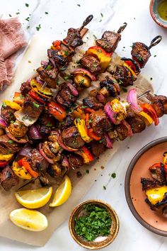 skewers of meat and vegetables on a table